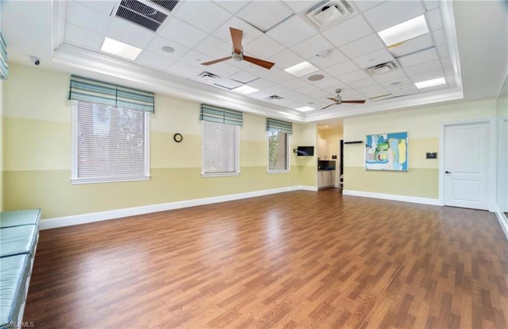 13628 Mandarin Circle Naples, FL 34109 - Photo 46 of 48 a view of an empty room with wooden floor and a window