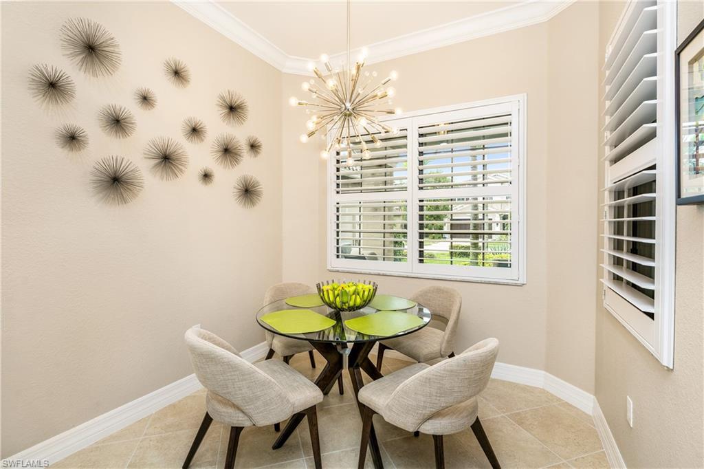 13628 Mandarin Circle Naples, FL 34109 - Photo 8 of 48 a view of a dining room with furniture and a chandelier