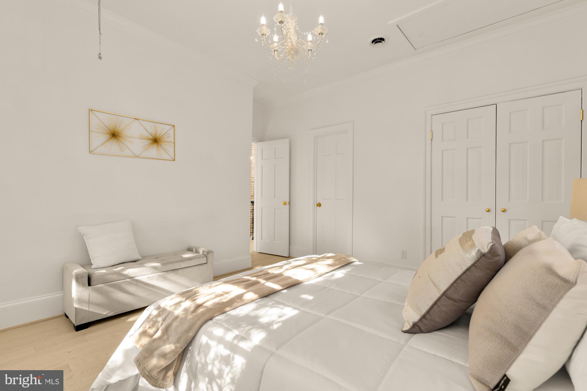 3249 P Street Northwest Washington, DC 20007 - Photo 38 of 59 a bedroom with a bed and a chandelier