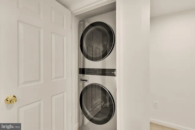 a bathroom with a granite countertop toilet sink and mirror