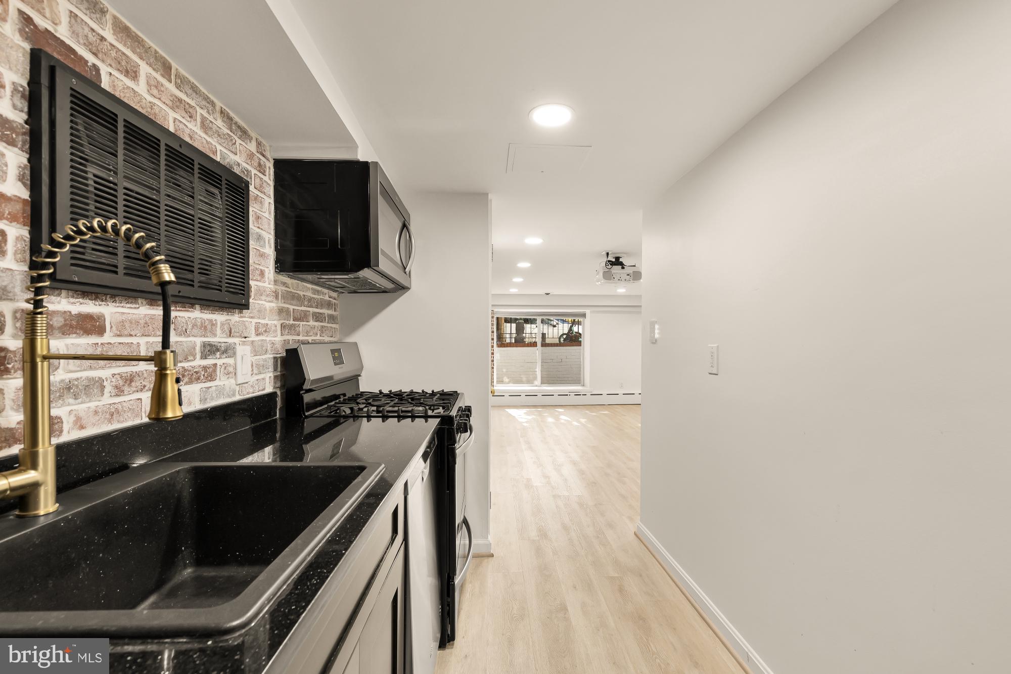 3249 P Street Northwest Washington, DC 20007 - Photo 44 of 59 a kitchen with a sink and a stove top oven