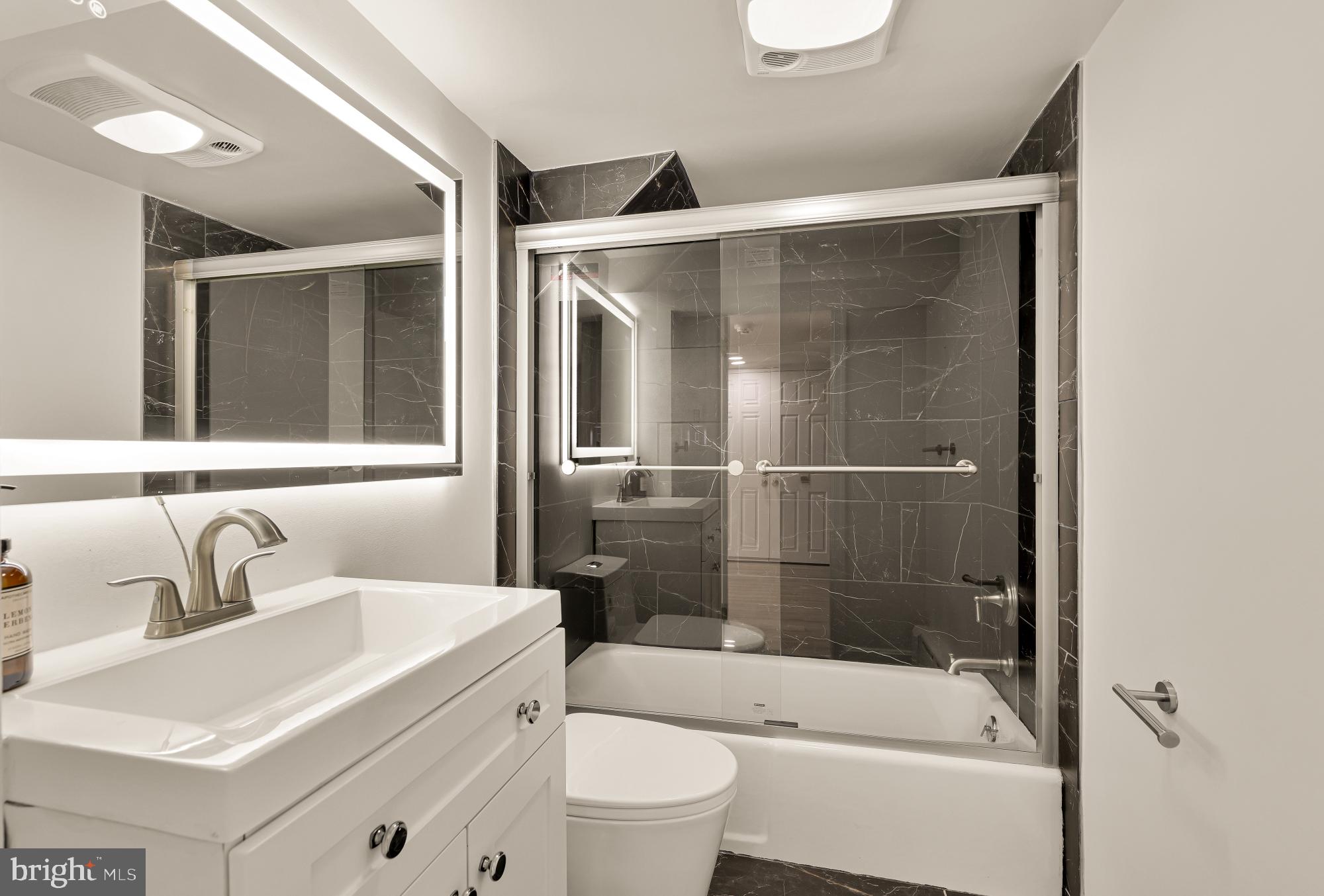 3249 P Street Northwest Washington, DC 20007 - Photo 45 of 59 a bathroom with a sink a toilet and shower