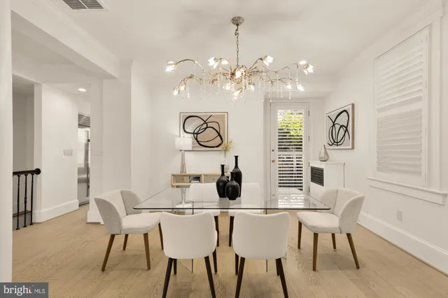 a view of a dining room with furniture and a chandelier
