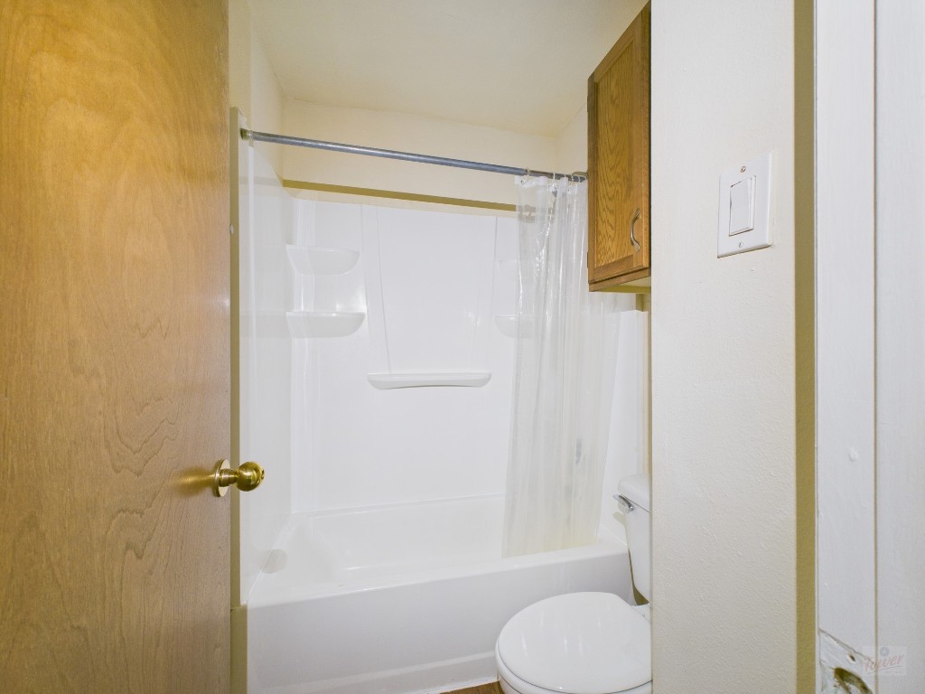 2815 Rio Grande Street, Unit 110 Austin, TX 78705 - Photo 8 of 10 a bathroom with a shower and toilet