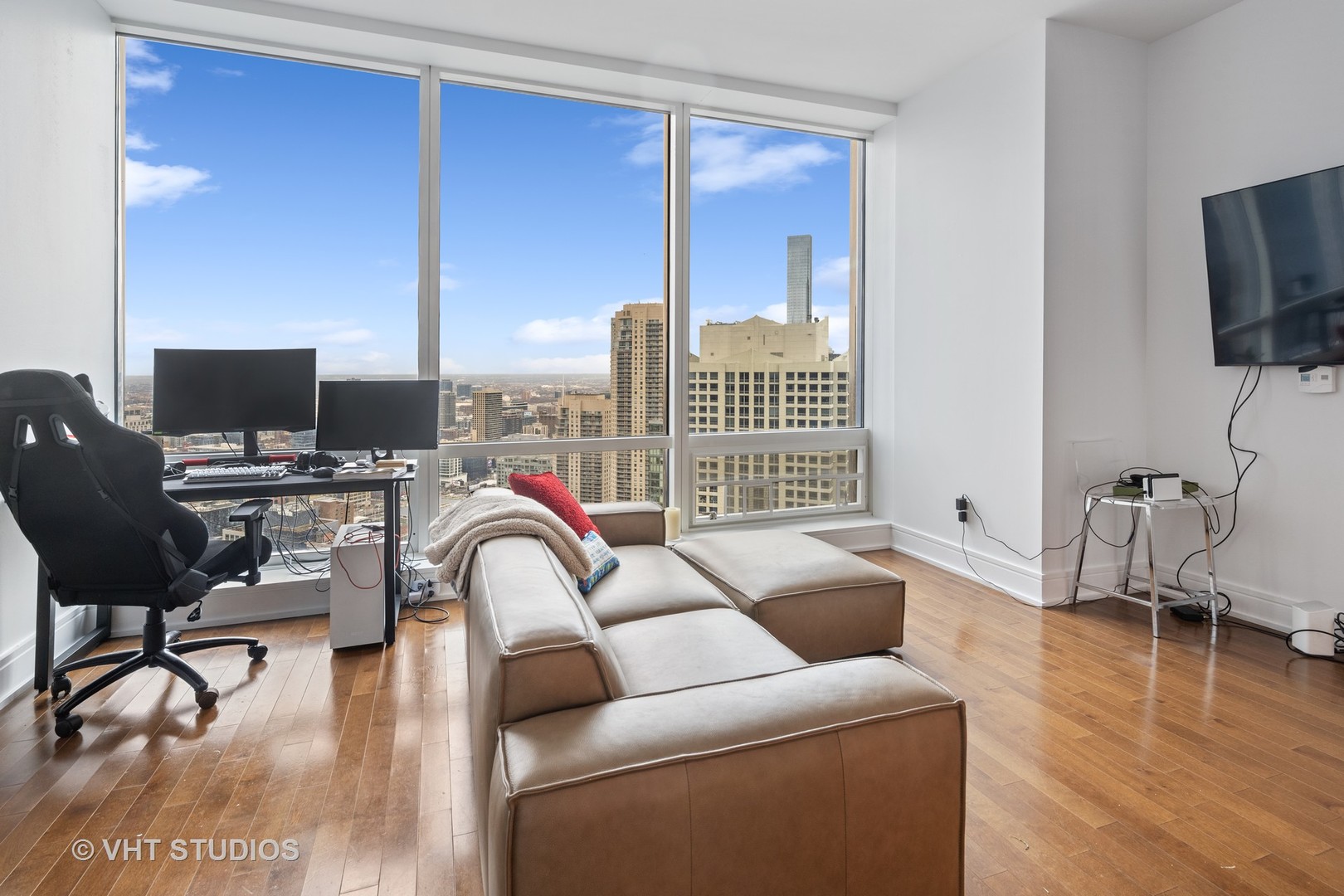 401 North Wabash Avenue, Unit 30E Chicago, IL 60611 - Photo 2 of 13 a living room with furniture and a flat screen tv