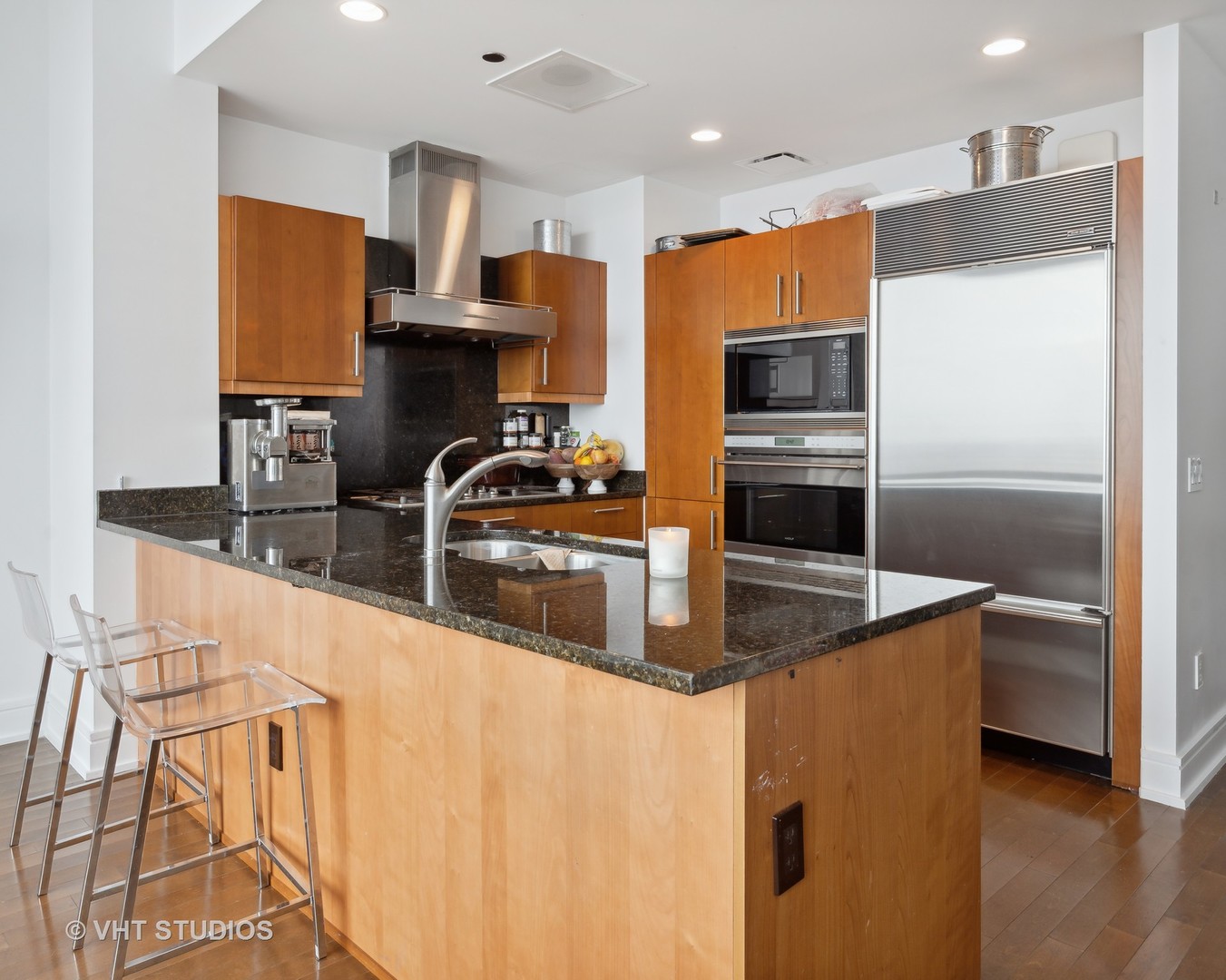 401 North Wabash Avenue, Unit 30E Chicago, IL 60611 - Photo 4 of 13 a kitchen with stainless steel appliances a sink a stove a microwave a sink and a refrigerator