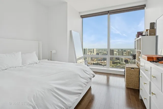 a bedroom with a large bed and a large window
