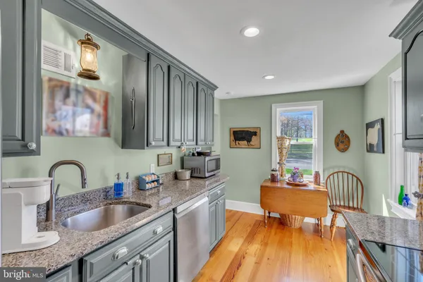 a living room with furniture floor to ceiling window and wooden floor