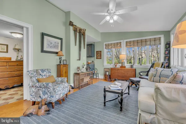 a living room with furniture and a lamp