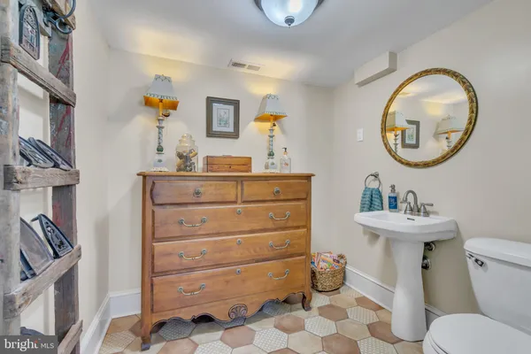 a bathroom with a sink mirror and window