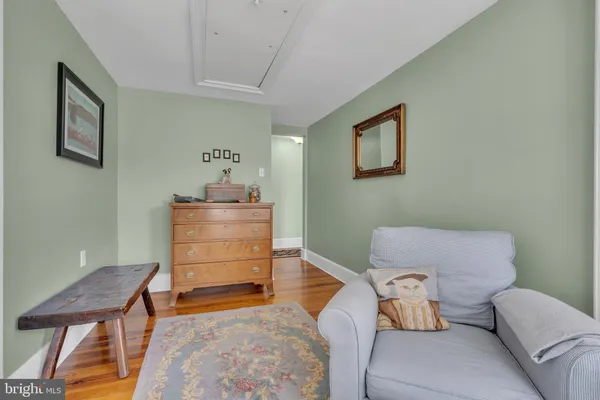 a front view of a house with a yard and tree