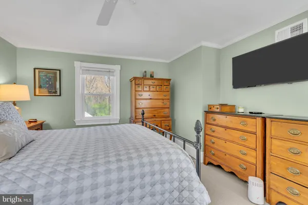 a picture of floor with a white wall and a painting