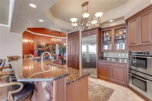 a kitchen with stainless steel appliances granite countertop a refrigerator and cabinets