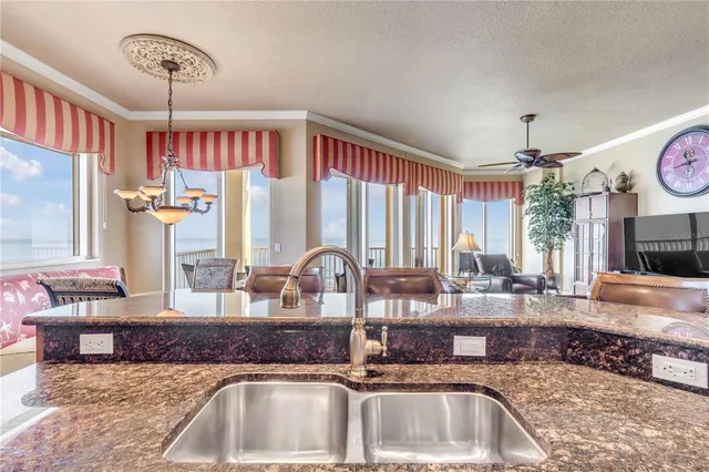 a living room with furniture a flat screen tv and a large window