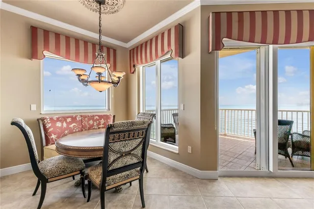 a living room with furniture a chandelier and a fireplace