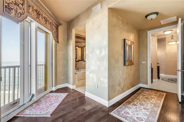 a spacious bathroom with a tub sink and mirror