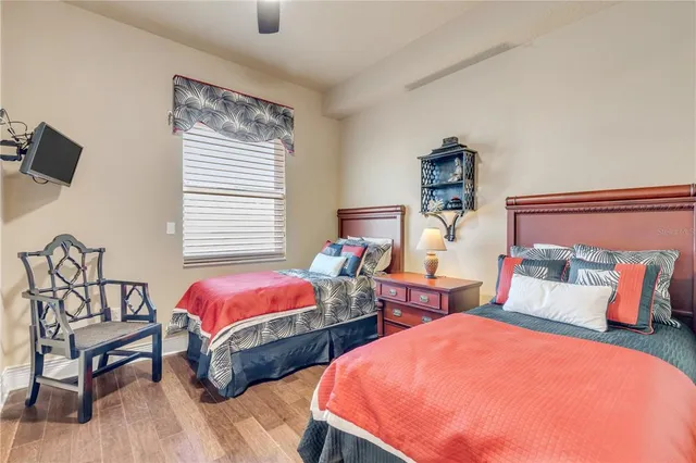 a bathroom with a granite countertop bathtub sink vanity mirror and toilet