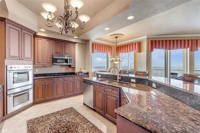 a kitchen with stainless steel appliances granite countertop a stove and cabinets