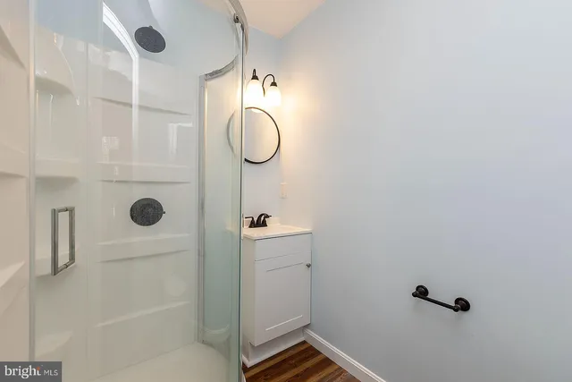 a bathroom with a shower and mirror