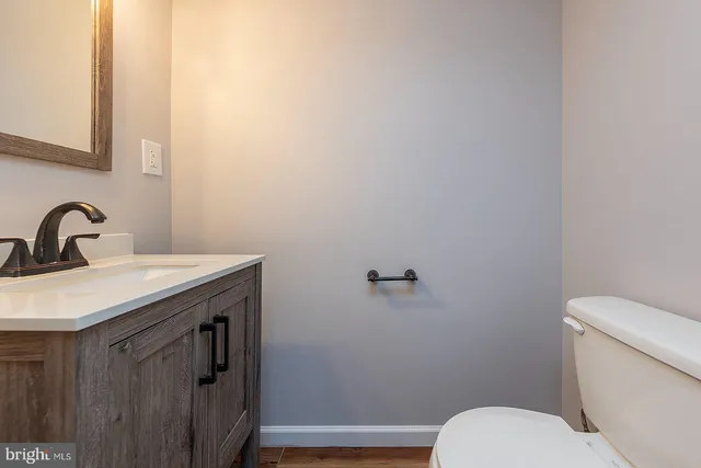 a bathroom with a sink a toilet and mirror