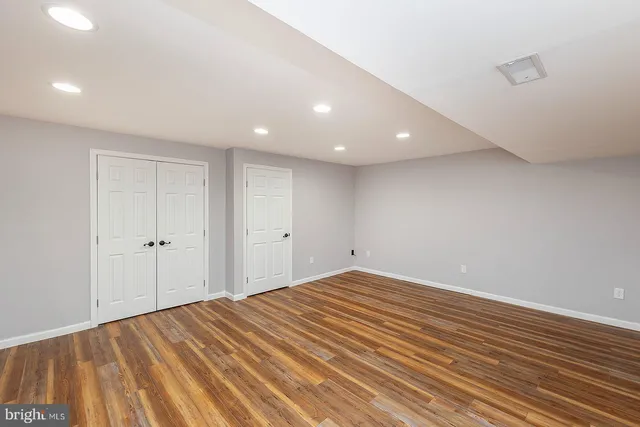 a view of room with wooden floor and white walls