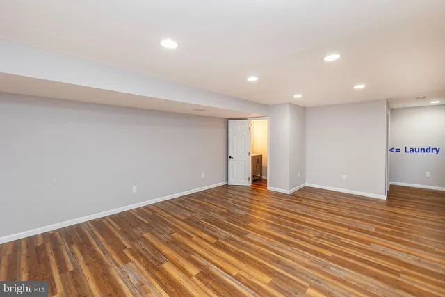 a view of an empty room and wooden floor