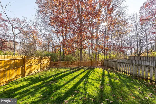 a view of a house with a wooden fence