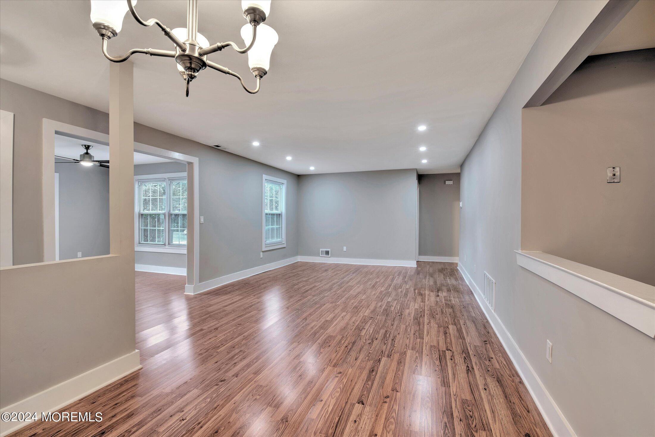 509 Harding Road, Unit 1 Freehold, NJ 07728 - Photo 23 of 43 a view of an empty room with wooden floor and a window