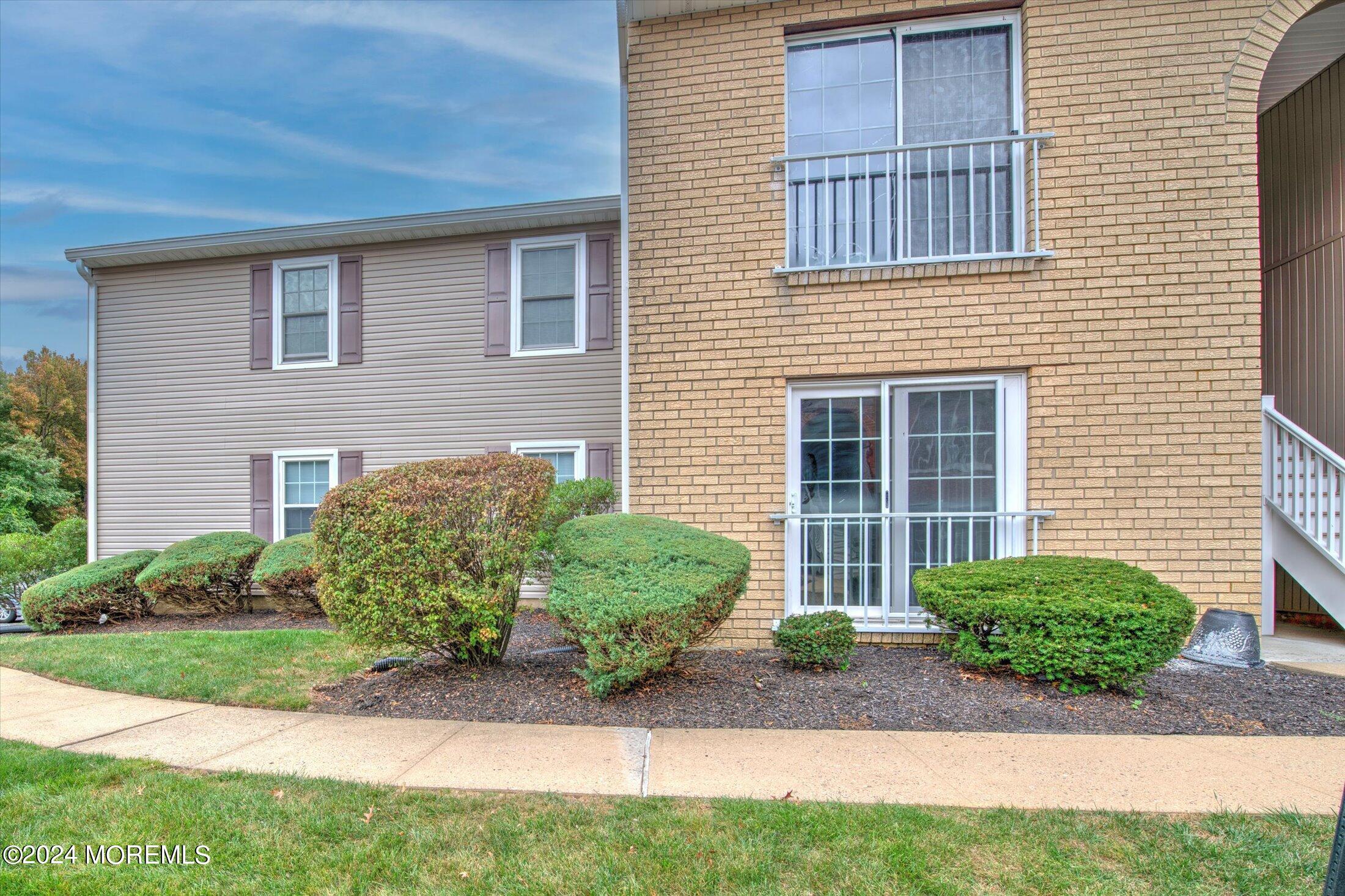 509 Harding Road, Unit 1 Freehold, NJ 07728 - Photo 41 of 43 a front view of a house with garden