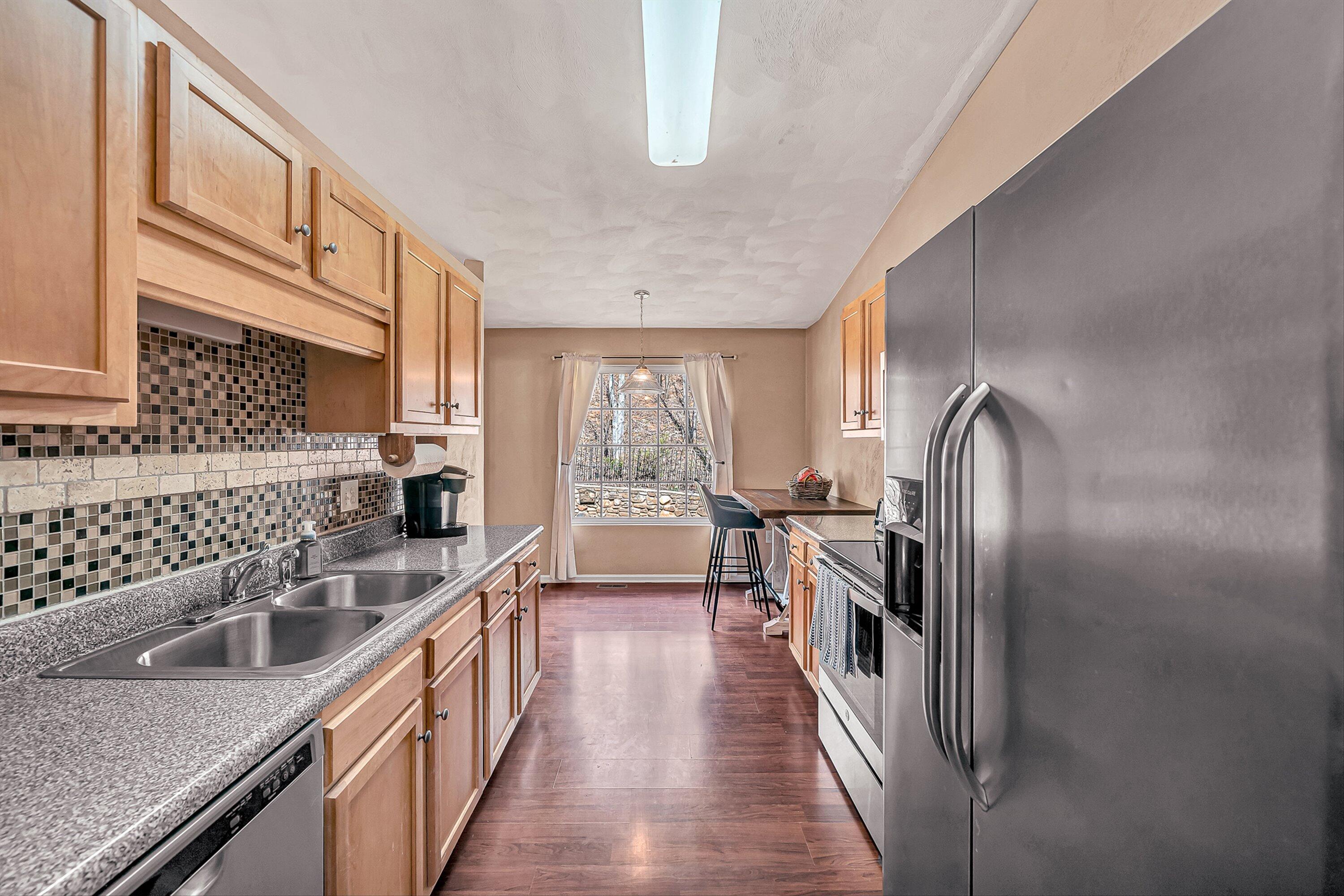4219 Daugherty Road Salem, VA 24153 - Photo 5 of 28 a kitchen with stainless steel appliances granite countertop a sink stove and refrigerator