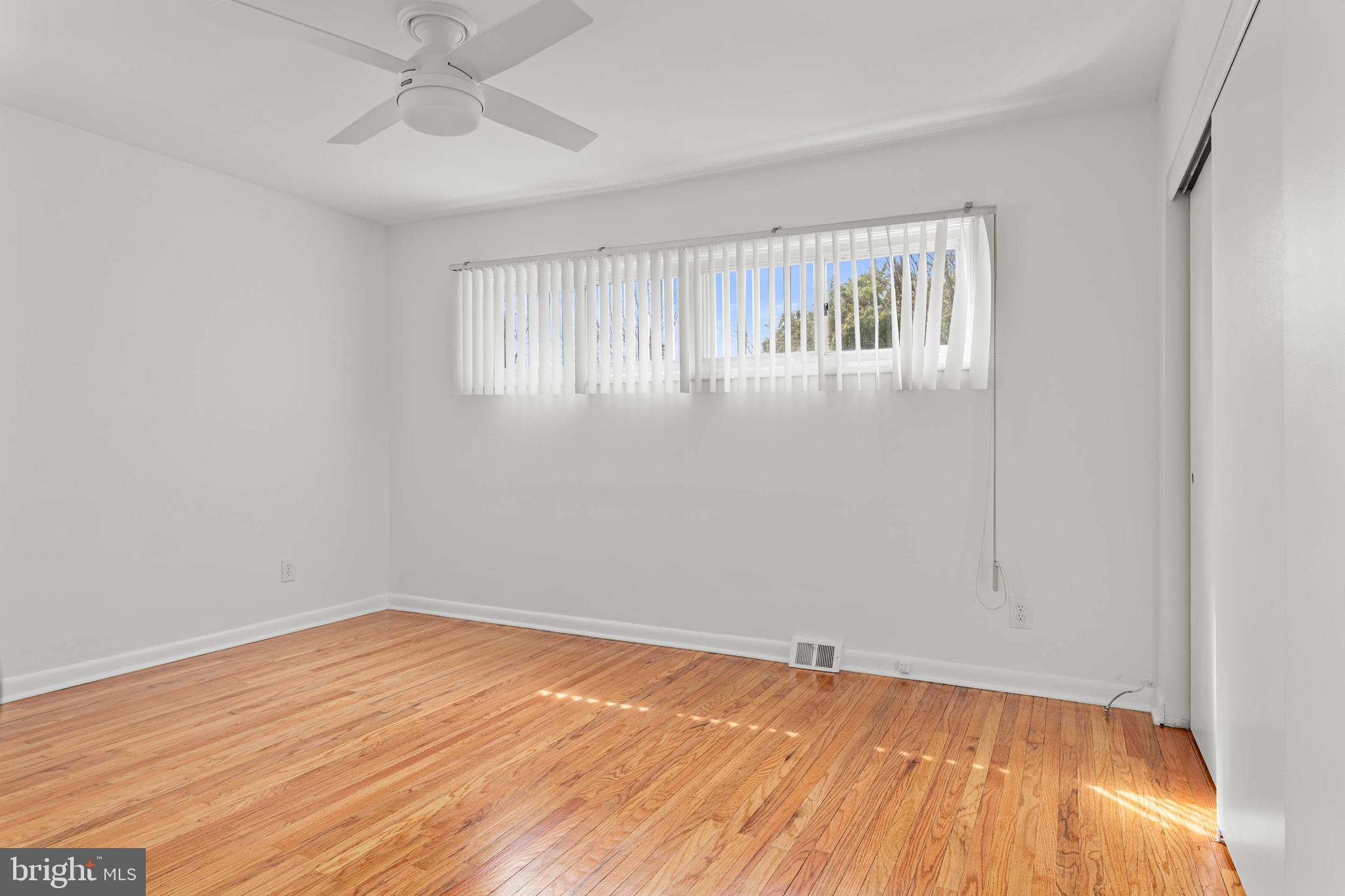 627 Wayland Road Plymouth Meeting, PA 19462 - Photo 26 of 40 a view of an empty room with wooden floor and a window