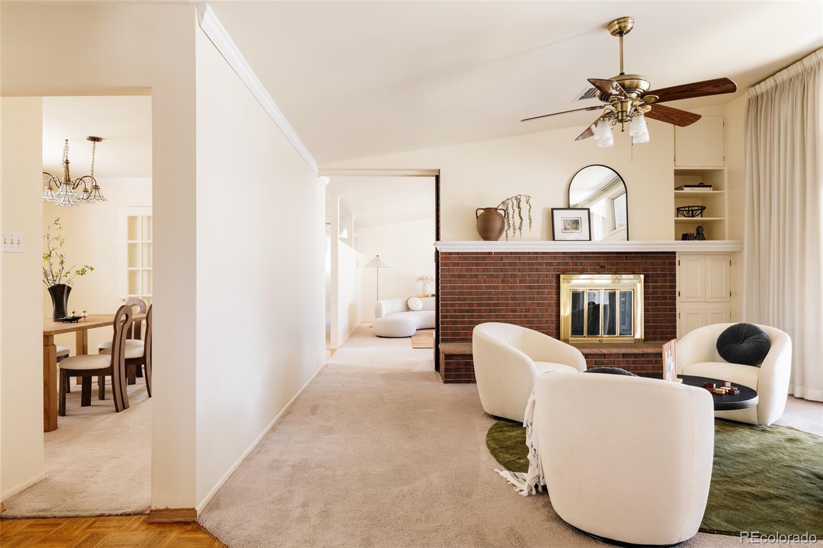 3095 Crabapple Road Golden, CO 80401 - Photo 12 of 50 a living room with furniture a fireplace and white walls