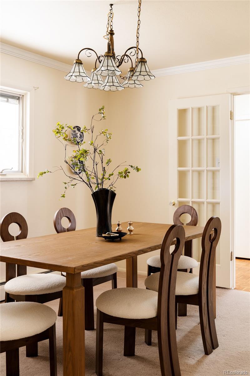 3095 Crabapple Road Golden, CO 80401 - Photo 13 of 50 a view of a dining room with furniture and chandelier