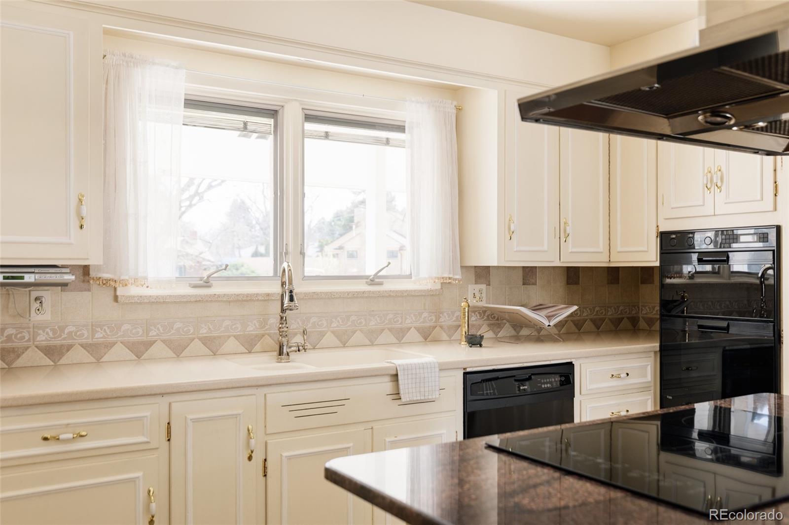 3095 Crabapple Road Golden, CO 80401 - Photo 17 of 50 a kitchen with stainless steel appliances granite countertop a sink a stove and cabinets