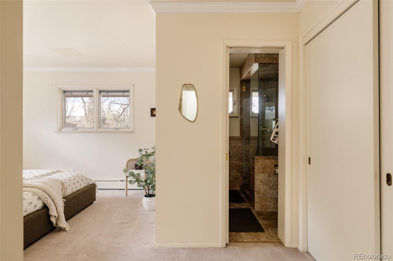 3095 Crabapple Road Golden, CO 80401 - Photo 21 of 50 a bedroom with a bed and a walk in closet