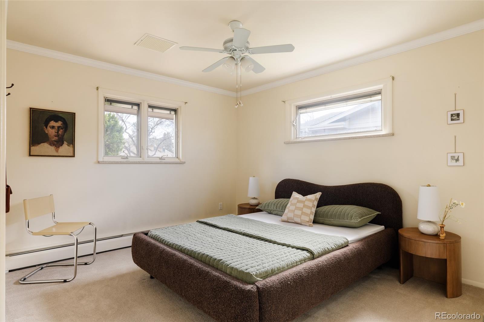 3095 Crabapple Road Golden, CO 80401 - Photo 27 of 50 a bedroom with a bed and a chandelier