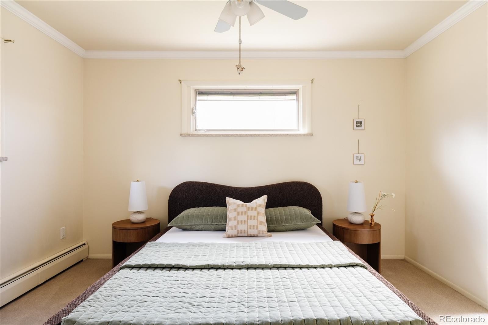 3095 Crabapple Road Golden, CO 80401 - Photo 28 of 50 a bedroom with a bed and a chandelier