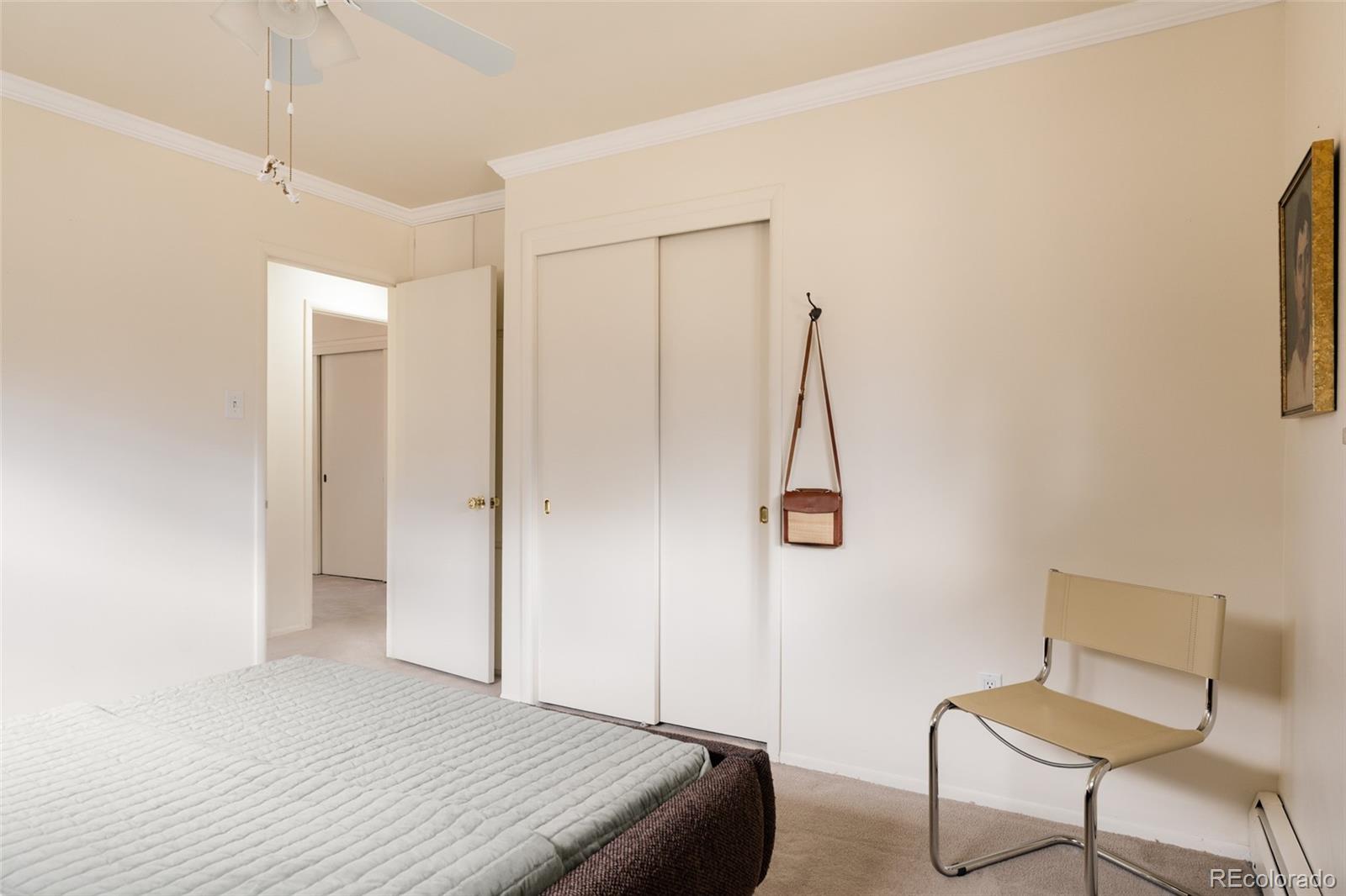 3095 Crabapple Road Golden, CO 80401 - Photo 29 of 50 a bedroom with a bed and a chair