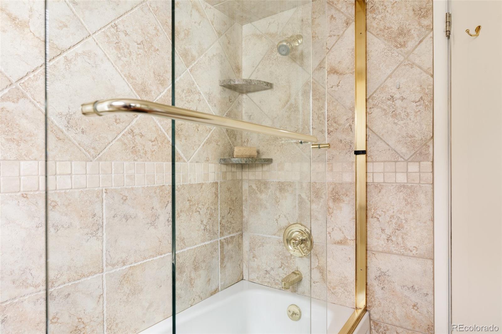 3095 Crabapple Road Golden, CO 80401 - Photo 31 of 50 a bathroom with a glass shower door