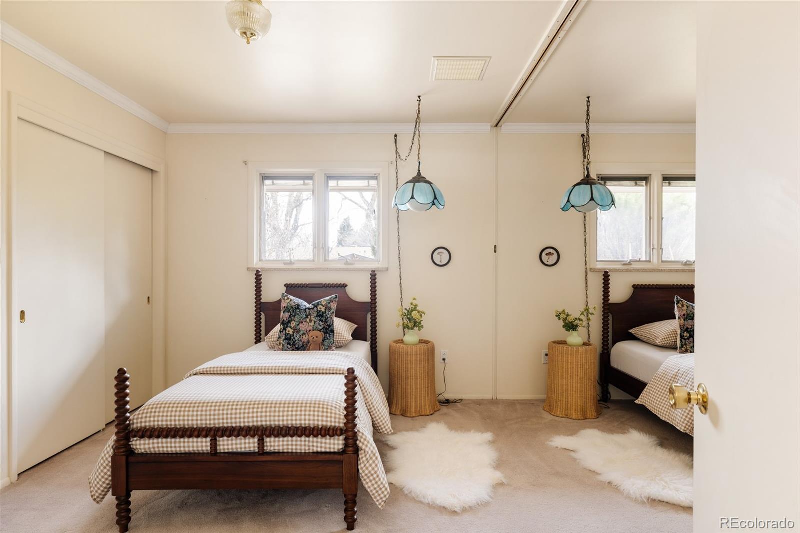 3095 Crabapple Road Golden, CO 80401 - Photo 32 of 50 a bedroom with a bed and a chandelier