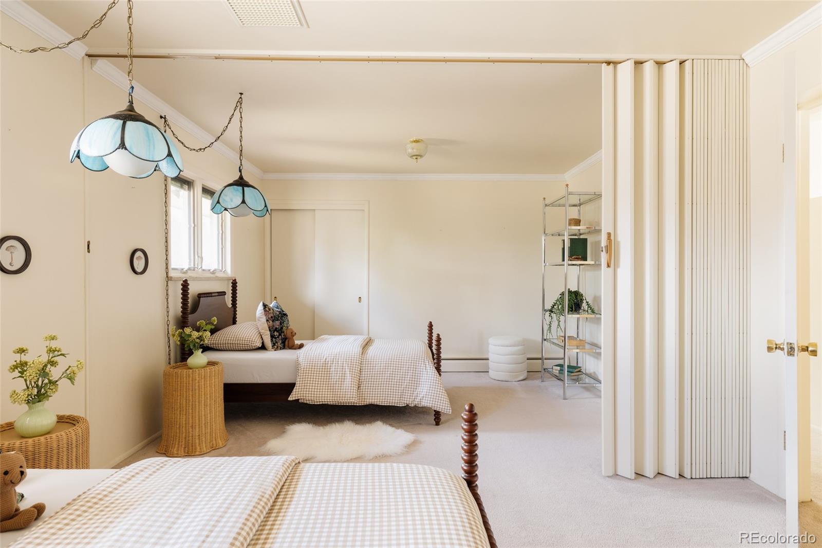 3095 Crabapple Road Golden, CO 80401 - Photo 33 of 50 a bedroom with furniture and a chandelier