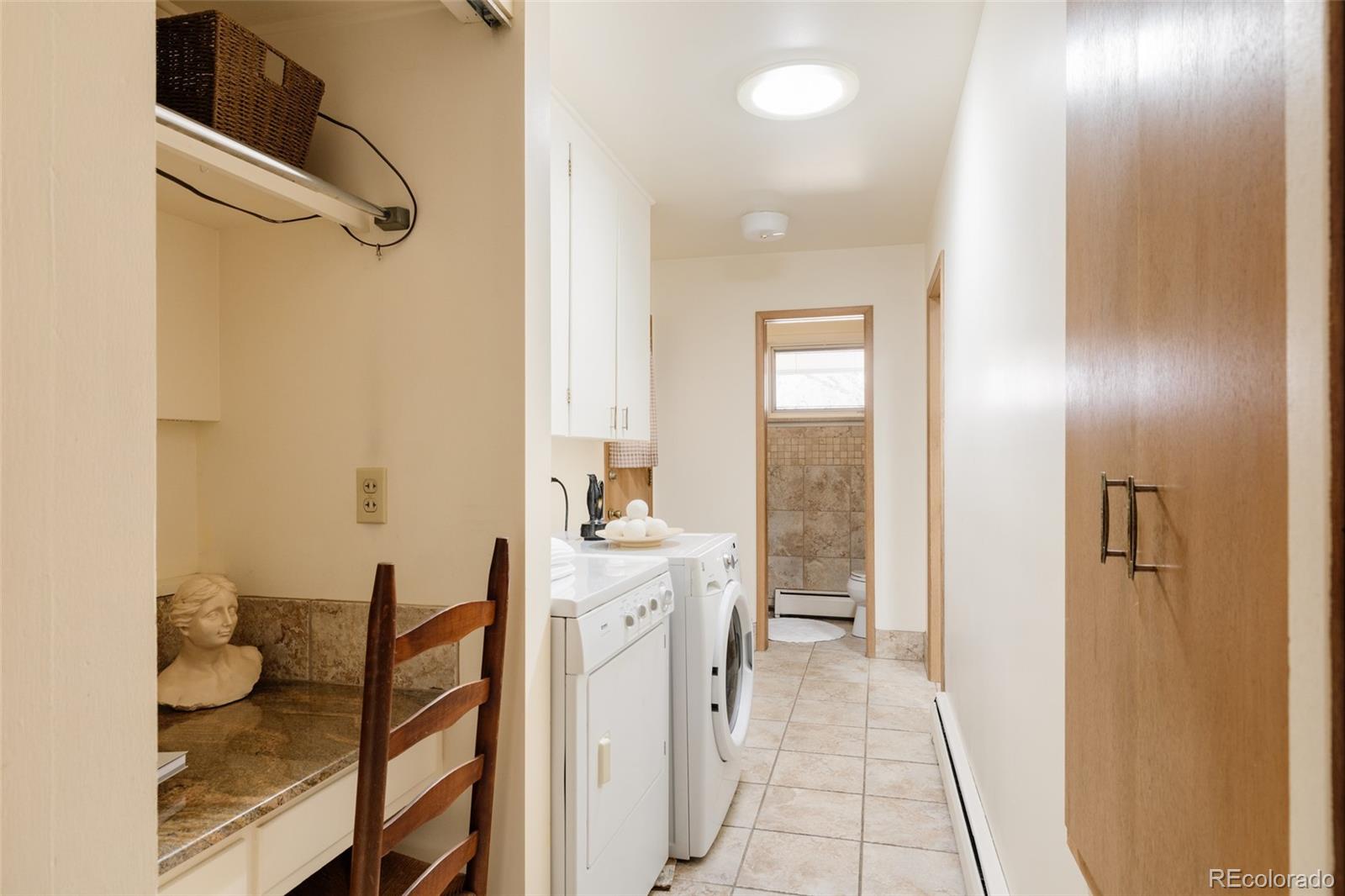 3095 Crabapple Road Golden, CO 80401 - Photo 36 of 50 a en suite bathroom with a granite countertop sink and a mirror