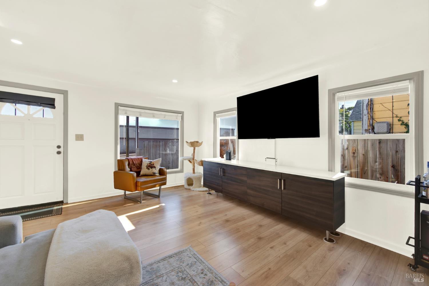 91 14th Street Vallejo, CA 94590 - Photo 12 of 48 a living room with furniture and a flat screen tv