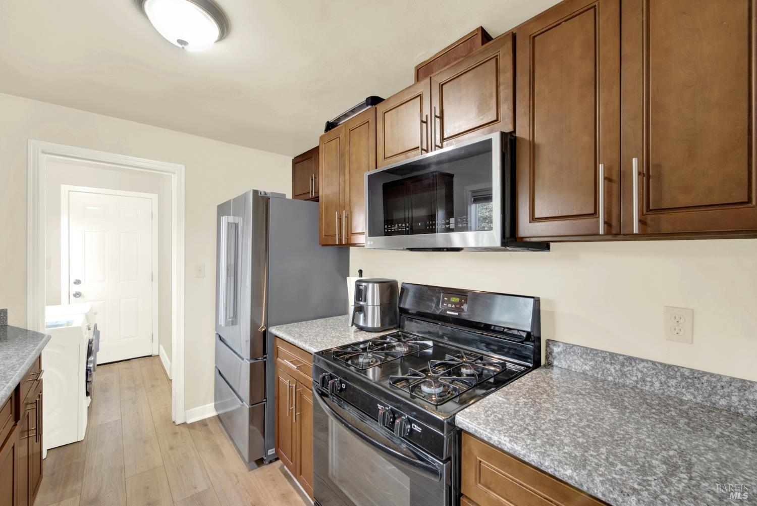 91 14th Street Vallejo, CA 94590 - Photo 19 of 48 a kitchen with stainless steel appliances granite countertop a stove refrigerator and microwave