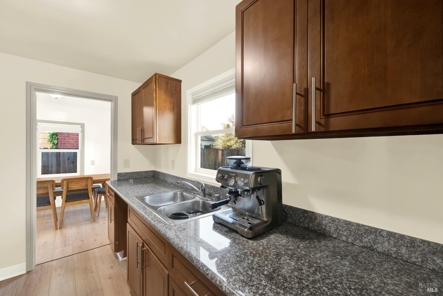 91 14th Street Vallejo, CA 94590 - Photo 24 of 48 a kitchen with granite countertop a sink a stove and cabinets