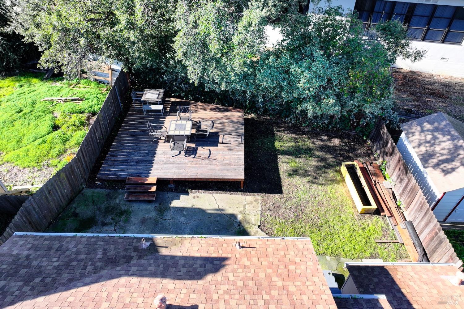 91 14th Street Vallejo, CA 94590 - Photo 37 of 48 a view of a patio with table and chairs with wooden floor and fence