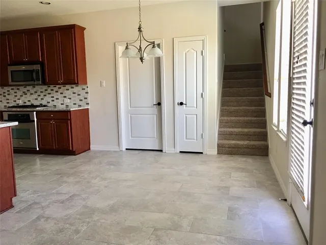 an empty room with a cabinet and mirrors