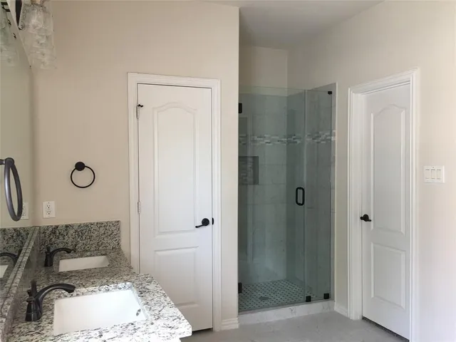 a bathroom with a sink and shower