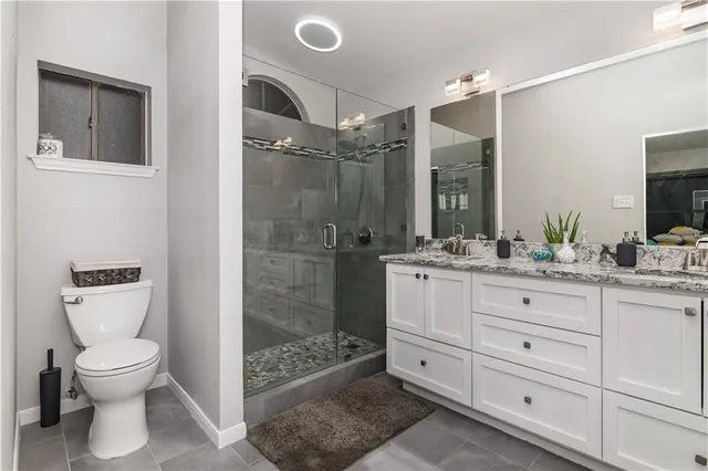 a bathroom with a toilet a sink and mirror