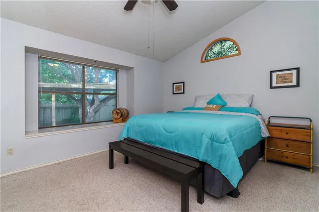 a bathroom with a granite countertop shower a sink and toilet